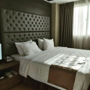 Elegant bedroom, bed with upholstered tufted headboard